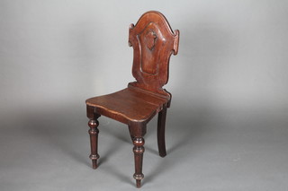 A Victorian mahogany hall chair with shield shaped back