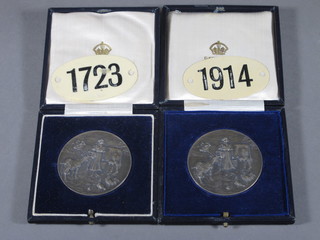 2 silver British Dairy Farmers Association medallions 2 1/2 ozs, cased together with 2 ear tags