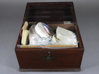 A mahogany box containing a collection of various beads