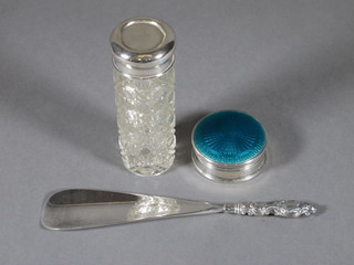 A circular silver rouge pot with hinged blue enamelled lid,  London 1928, 2 1/2", a silver handled shoe horn and a cylindrical cut glass dressing table jar with plated mount