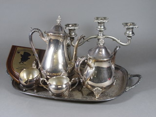 An oval silver plated twin handled tea tray, a silver plated 3 light candelabrum, a 4 piece silver plated tea/coffee service comprising  teapot, coffee pot, twin handled sugar bowl and milk jug, etc