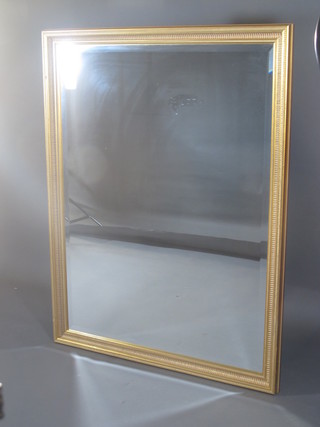 A square bevelled plate mirror contained in a decorative gilt  frame 39"w x 51"h