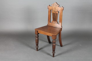 An Edwardian mahogany hall chair with pierced slat back raised  on cabriole supports