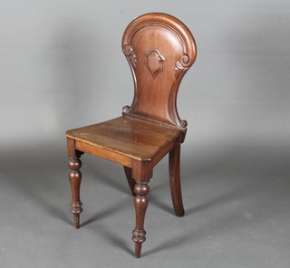 A Victorian mahogany hall chair with solid seat raised on turned supports
