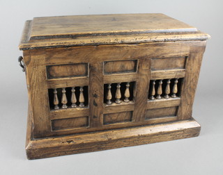 A miniature oak coffer of panelled construction with hinged lid,  raised on a platform base 15 1/2"w x 12"h x 10"d