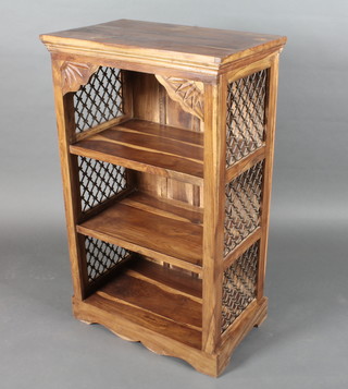 An Eastern hardwood bookcase with grilled iron panels to the side, raised on a platform base 25"w x 40"h x 16"d
