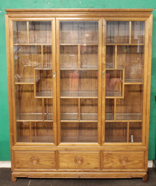 An Oriental hardwood display cabinet, the interior fitted numerous shelves, 61"w x 75"h x 16"d