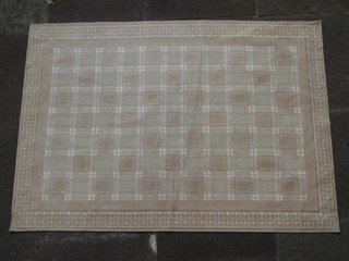 A contemporary fawn ground machine made rug 55" x 39"
