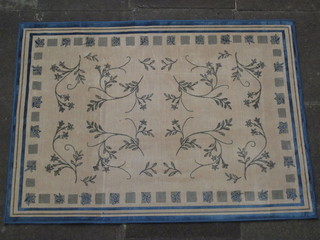 A machine made beige and blue contemporary rug with floral  decoration 55" x 38"