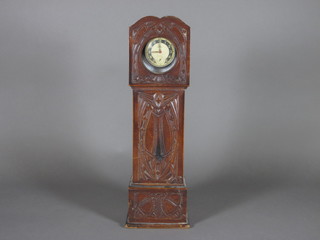 A carved wooden miniature longcase clock case fitted an Ingasol top wind pocket watch 12"