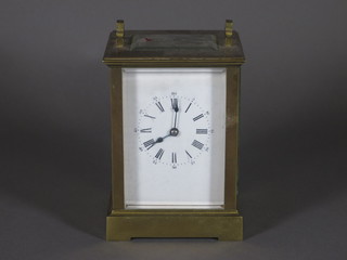 An 8 day carriage clock with enamelled dial contained in a gilt metal case, handle missing,