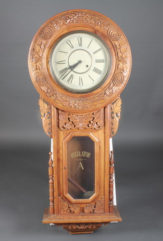 A large regulator style striking clock with 12" circular painted  dial, the door marked Regulator A, contained in a carved wooden  case  ILLUSTRATED