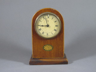 A Continental bedroom timepiece contained in an arch inlaid  mahogany case