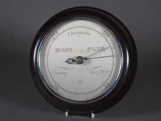 An aneroid barometer with silvered dial contained in a brown Bakelite case 7"