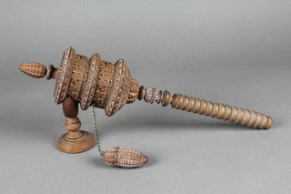 A turned and curved wooden Buddhist's prayer wheel