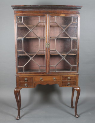 A Georgian mahogany display cabinet with moulded and Grecian  Key pattern cornice, the shelved interior enclosed by astragal  glazed panelled doors, the base fitted 1 long and 4 short drawers,  raised on cabriole supports 42"w x 71"h x 14"d   ILLUSTRATED