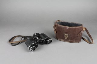 A pair of field glasses complete with leather carrying case