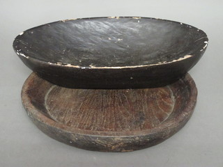 A wooden boat shaped dish 19" and a circular turned wooden  dish 16 1/2"