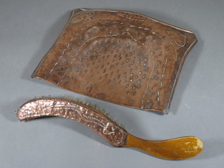 An Art Nouveau embossed copper crumb tray and brush 10"