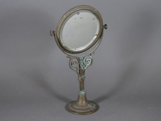 An Art Nouveau circular bevelled plate dressing table mirror  contained in a brass frame 13"