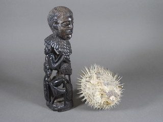 A carved African figure 12" and a Puffa fish 6"