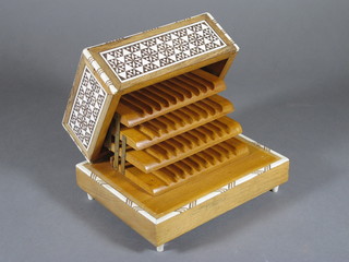 An Eastern hardwood inlaid ivory musical cigarette box with hinged lid 12"