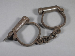 A pair of 19th Century steel handcuffs complete with keys