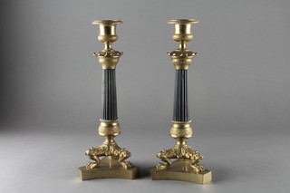A handsome pair of Empire gilt ormolu reeded candlesticks raised on triform bases 10"  ILLUSTRATED