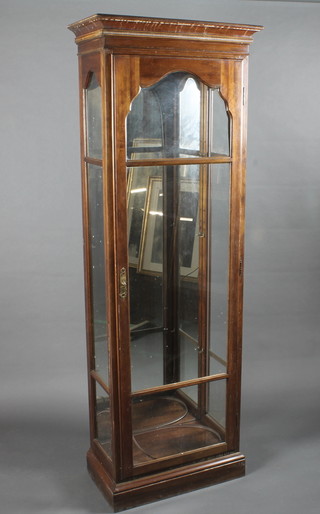 A mahogany display cabinet with moulded cornice and mirrored back enclosed by panelled doors 25"w x 73"h x 14"d