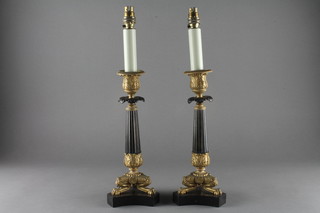 A pair of Empire ormolu and bronze reeded candlesticks raised  on tripod bases 9 1/2", converted to table lamps   ILLUSTRATED