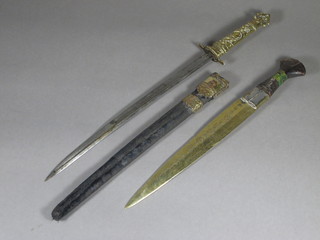 An Eastern dagger with 10" blade and 1 other dagger with 13  1/2" curved blade, gilt grip and complete with scabbard