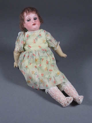 An Armand Marseille porcelain headed doll the head incised 300, with open and shutting eyes and open mouth with teeth, 11"