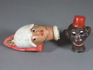A celluloid dolls head in the form of a guardsman and 1 other in the form of a monkey