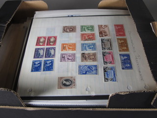A box containing various loose stamps etc