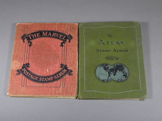 An Atlas stamp album and a Marvel postage stamp album