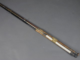 An Daiwa Senior carbon fibre twin section fishing rod, a Star Kali twin section boat rod and a wooden boat rod