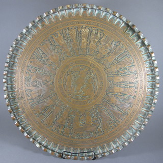 A circular embossed brass charger 28"