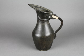 A bronze jug with old label marked 19th Century jug from the North West Frontier 12"