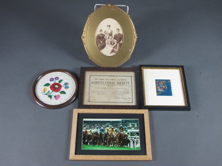 A Victorian black and white photograph of a seated family 7"   oval contained in a decorative gilt frame, a circular embroidered  panel decorated a rose in a mahogany frame, a coloured  photograph of a horse race 6" x 9 1/2", an Agricultural Society  certificate in an oak frame 7" x 9 1/2" and a framed piece of an  Antique silk Kimono 4" x 3 1/2"