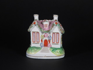 A 19th Century Staffordshire money box in the form of a cottage 4 1/2"