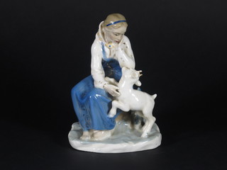 A 1940's Russian USSR porcelain figure of a seated girl with kid goat 7" from the Lomonosov factory