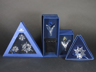 4 Swarovski star shaped Christmas tree ornaments together with 2 Swarovski models of tulips