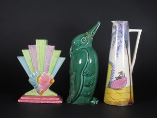An Art Deco pottery waisted vase decorated a crinoline lady 11",  a Myotts fan shaped vase 8" and a Velray pottery hotwater  bottle/flask in the form of a penguin 11"