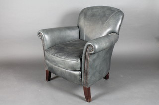An armchair upholstered in blue leather material raised on  bracket feet
