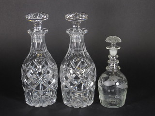 A pair of club shaped cut glass decanters and stopper 11" and an etched glass decanter and stopper 8"