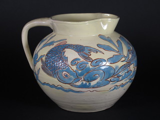 A Brannam yellow glazed jug decorated fish the base marked C  H Brannam 9", spout restored,