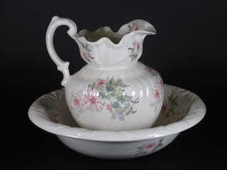 A floral patterned jug and bowl set, chip to spout of jug,