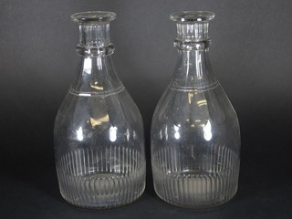 A large pair of Georgian panel cut decanters 12"