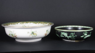 A circular green floral patterned bowl 6" and a black glazed bowl decorated storks 12"