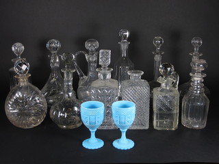 A collection of 14 cut glass decanters and 2 blue glass goblets